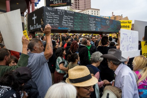 A symbolic casket bearing the names of people killed by APD was carried to police headquarters. Photo by Luke Montavon, The Jackalope.