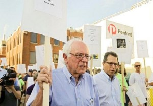 Presidential candidate Bernie Sanders pickets with Iowa workers last week. As a senator, Sanders also recently introduced legislation that would guarantee paid vacation time to full-time workers.