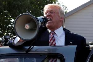 Republican presidential nominee Donald Trump speaks to supporters through a bullhorn during a campaign stop at the Canfield County Fair in Canfield
